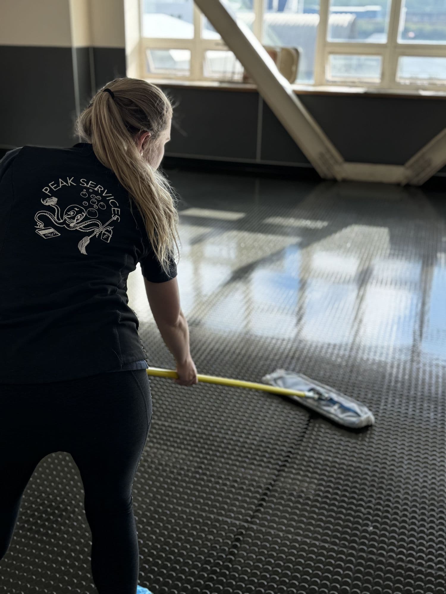 Hard floor maintenance by a Peak Services floor care technician