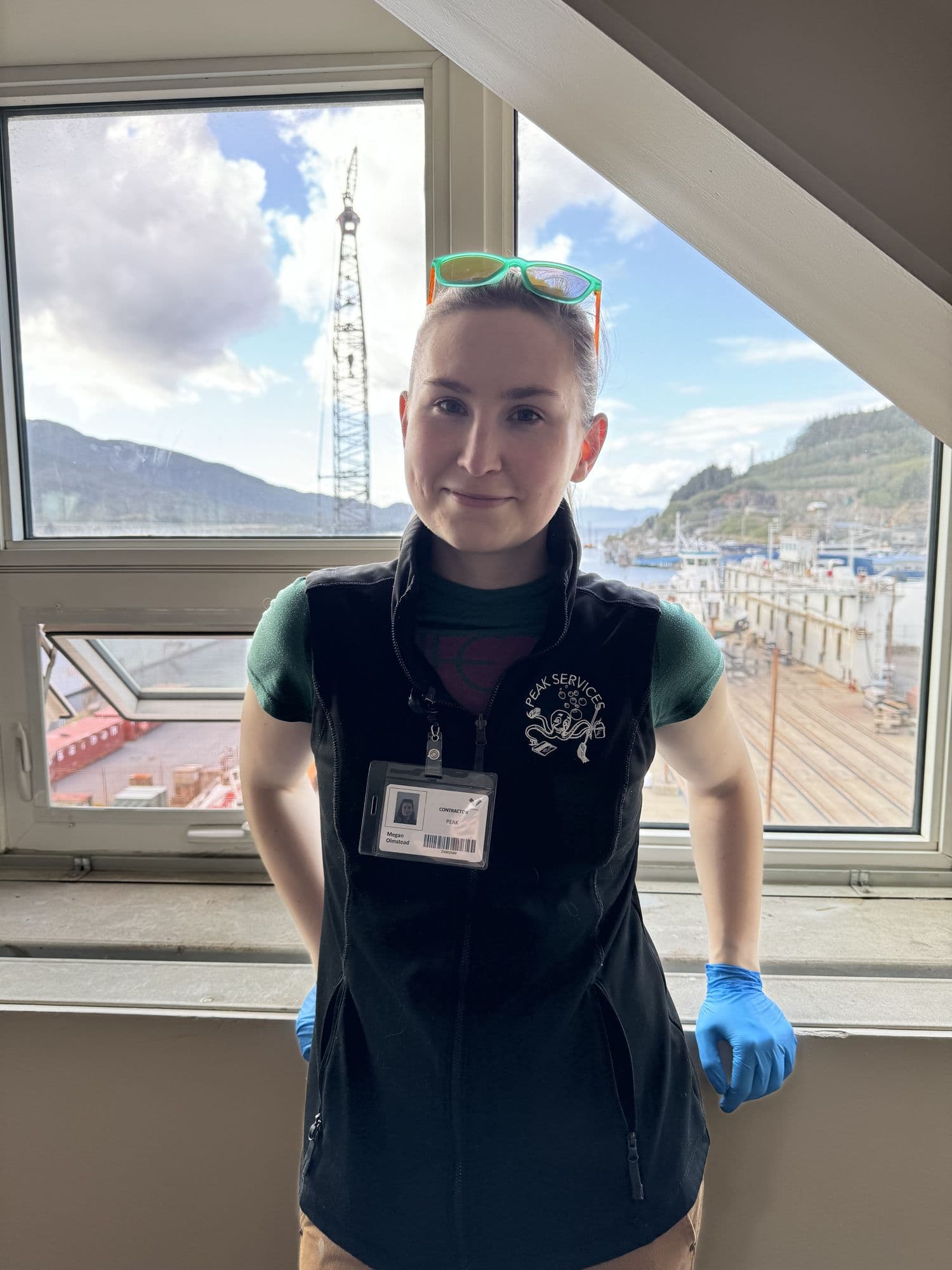 A Peak Services technician washing windows in a Southeast Alaska home