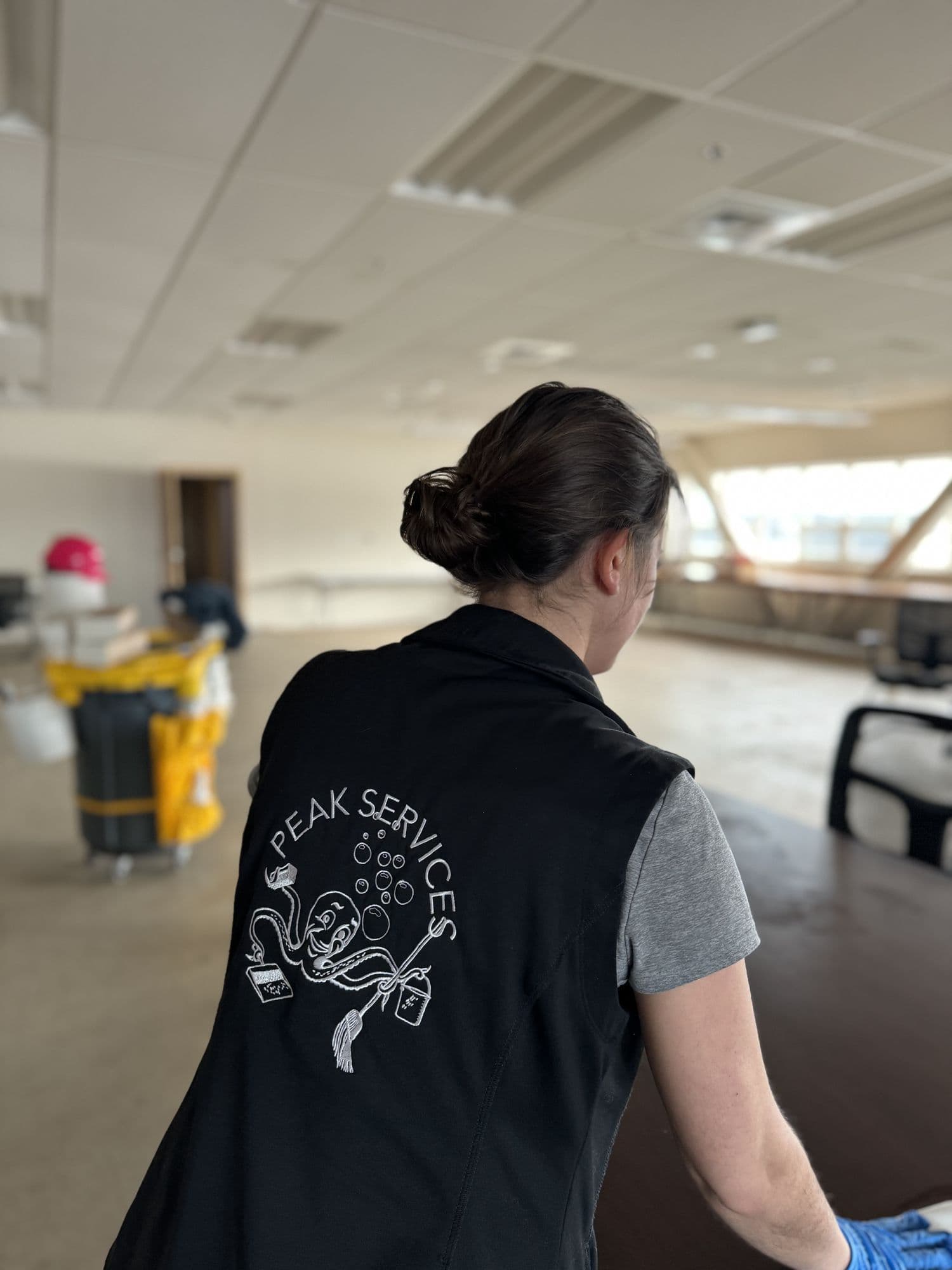 A Peak Services technician cleaning a commercial lobby